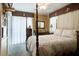 Spacious bedroom featuring a four-poster bed, ceiling fan, and curtains, creating a comfortable retreat at 344 Lantana Dr, Charleston, SC 29407