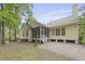 Yellow home features a screened in back porch and patio at 3520 E Higgins Dr, Mount Pleasant, SC 29466