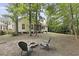 Landscaped backyard featuring a fire pit and a view of the home's exterior at 3520 E Higgins Dr, Mount Pleasant, SC 29466