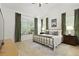 Bright bedroom boasts a vaulted ceiling, a metal bed frame, and dual windows with verdant curtains at 3520 E Higgins Dr, Mount Pleasant, SC 29466