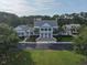 Exterior elevation of a white two-story clubhouse with large columns and a well manicured green lawn at 3520 E Higgins Dr, Mount Pleasant, SC 29466