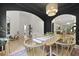 Well-lit dining space featuring dark walls, a woven chandelier, and elegant archways to other rooms at 3520 E Higgins Dr, Mount Pleasant, SC 29466