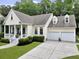 Charming home with a inviting front porch, well-manicured lawn, and attached two-car garage at 3520 E Higgins Dr, Mount Pleasant, SC 29466