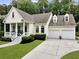 Charming home with a inviting front porch, well-manicured lawn, and attached two-car garage at 3520 E Higgins Dr, Mount Pleasant, SC 29466