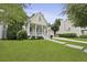 A well-maintained home with a charming front porch and lush green lawn, inviting and picturesque at 3520 E Higgins Dr, Mount Pleasant, SC 29466