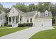 Charming home with a inviting front porch, well-manicured lawn, and attached two-car garage at 3520 E Higgins Dr, Mount Pleasant, SC 29466