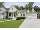 Charming home with a inviting front porch, well-manicured lawn, and attached two-car garage at 3520 E Higgins Dr, Mount Pleasant, SC 29466