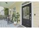 Inviting front porch features rocking chairs and a beautifully designed front door with glass detail at 3520 E Higgins Dr, Mount Pleasant, SC 29466