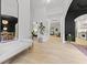 Bright entryway with pristine white walls, light wood floors, and views into various rooms at 3520 E Higgins Dr, Mount Pleasant, SC 29466