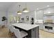 Bright kitchen with stainless steel range, gray cabinets, and center island with seating and modern lighting at 3520 E Higgins Dr, Mount Pleasant, SC 29466