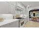 Bright kitchen featuring white cabinets, marble countertops, and a view into the dining area at 3520 E Higgins Dr, Mount Pleasant, SC 29466
