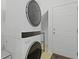Modern laundry room featuring stacked washer and dryer unit at 3520 E Higgins Dr, Mount Pleasant, SC 29466