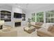 Spacious living room with fireplace, built-in shelves, large windows, and a comfortable leather sectional at 3520 E Higgins Dr, Mount Pleasant, SC 29466