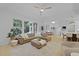 Open living room with large windows, fireplace, built-ins, and a leather sectional sofa at 3520 E Higgins Dr, Mount Pleasant, SC 29466