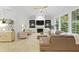 Bright living room featuring fireplace, built-ins, large windows, and comfortable furniture at 3520 E Higgins Dr, Mount Pleasant, SC 29466