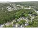 Aerial view of a wooded neighborhood showcasing mature trees, single Gathering homes, and manicured lawns at 3520 E Higgins Dr, Mount Pleasant, SC 29466