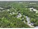 Aerial view of a wooded neighborhood showcasing mature trees, single Gathering homes, and a pond at 3520 E Higgins Dr, Mount Pleasant, SC 29466