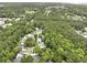 Aerial view of a wooded neighborhood showcasing mature trees, single Gathering homes, and manicured lawns at 3520 E Higgins Dr, Mount Pleasant, SC 29466