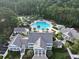 Aerial view of a community pool with water slide, lounge chairs, mature trees, and clubhouse at 3520 E Higgins Dr, Mount Pleasant, SC 29466