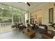 Inviting screened-in porch with comfortable seating, wood floors, and natural views at 3520 E Higgins Dr, Mount Pleasant, SC 29466