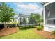 Spacious backyard with well-maintained lawn, featuring a trampoline and access to the screened porch at 3707 Gambrill Ln, Mount Pleasant, SC 29466