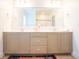 Bathroom with double sinks, stone countertops, and traditional cabinets at 3707 Gambrill Ln, Mount Pleasant, SC 29466