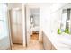 Bathroom vanity with dual sinks, bright lighting, and a view into the shower and bedroom at 3707 Gambrill Ln, Mount Pleasant, SC 29466