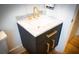 Dark wood vanity, white marble counters, and gold hardware create a luxurious bathroom at 3707 Gambrill Ln, Mount Pleasant, SC 29466
