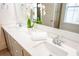 Close-up view of a bathroom vanity featuring dual sinks, ample counter space, and a decorative orchid at 3707 Gambrill Ln, Mount Pleasant, SC 29466