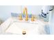 Close up on modern bathroom's white marble countertop and gold fixtures at 3707 Gambrill Ln, Mount Pleasant, SC 29466