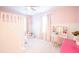 Bright bedroom features a lofted bed, vanity with storage, and a comfortable sitting area at 3707 Gambrill Ln, Mount Pleasant, SC 29466