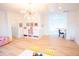 Bright bonus room with hardwood floors, art, storage and seating at 3707 Gambrill Ln, Mount Pleasant, SC 29466