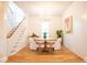 Bright dining area featuring shiplap walls, wood floors, modern chandelier, and staircase access at 3707 Gambrill Ln, Mount Pleasant, SC 29466