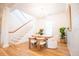 Bright dining area featuring wood floors, a round table, chandelier, and a staircase in the background at 3707 Gambrill Ln, Mount Pleasant, SC 29466