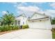 Rear view of a white two-story home with a detached garage and lush landscaping, showcasing its classic design at 3707 Gambrill Ln, Mount Pleasant, SC 29466
