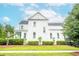 Side view of a white two-story home with a manicured lawn and lush landscaping, showcasing its classic design at 3707 Gambrill Ln, Mount Pleasant, SC 29466