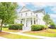 Charming two-story home with a inviting front porch, well-manicured lawn, and lush landscaping at 3707 Gambrill Ln, Mount Pleasant, SC 29466