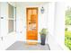 Inviting front porch featuring a natural wood door with glass panels and stylish decor, creating a warm welcome at 3707 Gambrill Ln, Mount Pleasant, SC 29466