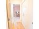 Hallway leading to a bedroom with a vanity, pink walls, and closet doors on the right at 3707 Gambrill Ln, Mount Pleasant, SC 29466