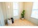 Well-lit laundry room showcasing tile floor, window, and shelving for organized storage at 3707 Gambrill Ln, Mount Pleasant, SC 29466