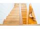 Bright view of a hardwood staircase with a light wood banister and white walls at 3707 Gambrill Ln, Mount Pleasant, SC 29466