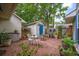 View of brick backyard patio featuring a bistro set and storage shed at 39 Indigo Ln, Goose Creek, SC 29445