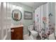 Charming bathroom with a vanity, floral shower curtain, and ample lighting for a relaxing experience at 39 Indigo Ln, Goose Creek, SC 29445