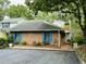 Exterior view of a charming brick home with blue shutters and a landscaped yard at 39 Indigo Ln, Goose Creek, SC 29445