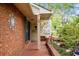 Home's welcoming front porch with brick flooring and decorative welcome sign at 39 Indigo Ln, Goose Creek, SC 29445