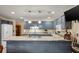 Bright kitchen features blue cabinets, stainless steel appliances, and a stone countertop island for cooking and entertaining at 39 Indigo Ln, Goose Creek, SC 29445