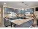 Charming kitchen boasts blue cabinets, stainless steel appliances and a light and airy stone countertop at 39 Indigo Ln, Goose Creek, SC 29445