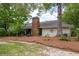 Charming home featuring a brick chimney and surrounded by mature trees at 39 Indigo Ln, Goose Creek, SC 29445