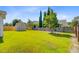 Grassy backyard including a fenced perimeter, mature trees, and shed for extra storage space at 407 Glenmore Dr, Moncks Corner, SC 29461