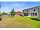 Expansive backyard with lush green grass and a partial view of a screened porch and storage shed at 407 Glenmore Dr, Moncks Corner, SC 29461